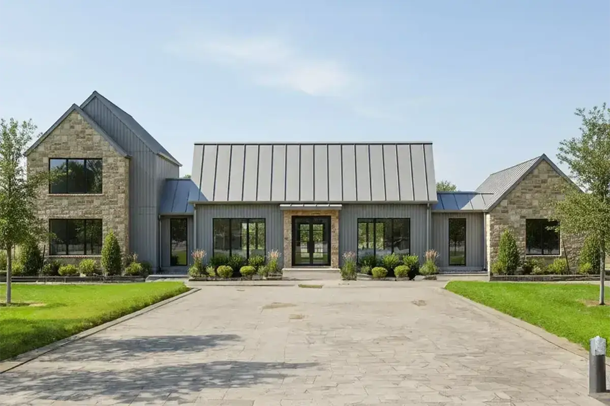 Photorealistic rendering of a modern farmhouse with stone walls and a standing seam metal roof, made from a Revit facade with RenderAI