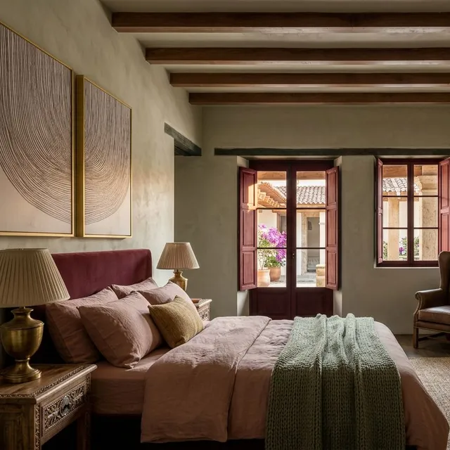 Rustic bedroom with timber beams restyled with terracotta bedding, antique chests and a leather armchair, rendered from an existing render with Render AI